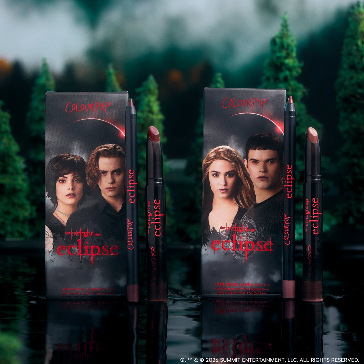 ColourPop Twilight Immortal Kiss Lippie Stix Duo stands upright on a reflective lake surface, with Eclipse-themed character boxes and matching deep nude and berry lip pencils and sticks framed by a dark, misty forest backdrop.