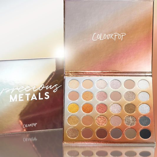 ColourPop Precious Metals shadow palette opens to reveal warm neutrals and metallic shimmers - gold, bronze, copper, taupe, silver, and black - in a reflective rose-gold case beside the matching box; a standout ColourPop Shadow Palette for glam lids.