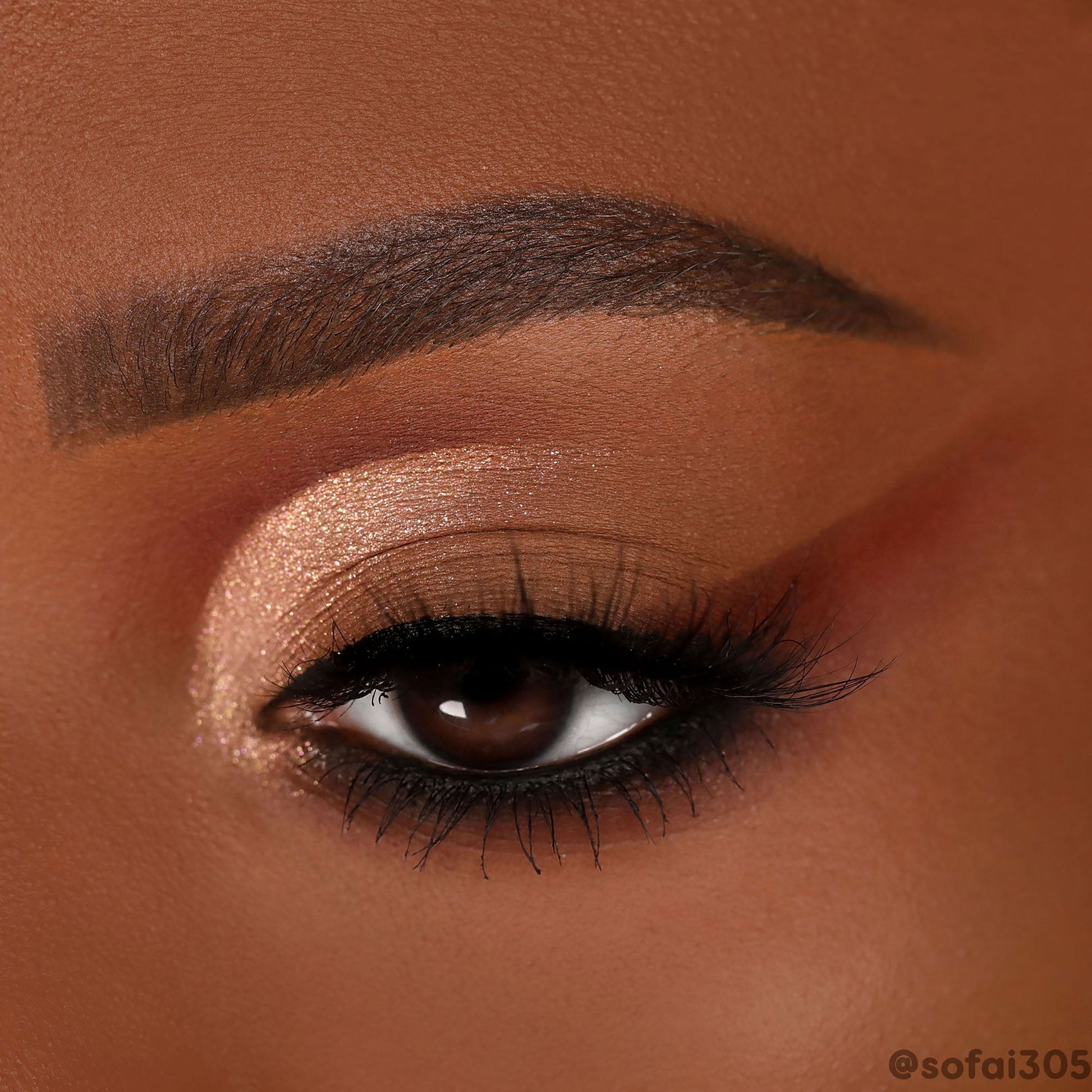 Rose-gold shimmer and warm terracotta mattes sweep across a single eye, creating a soft wing with black liner and lush lashes, showcasing the By The Rosé ColourPop Shadow Palette in a close-up beauty shot.