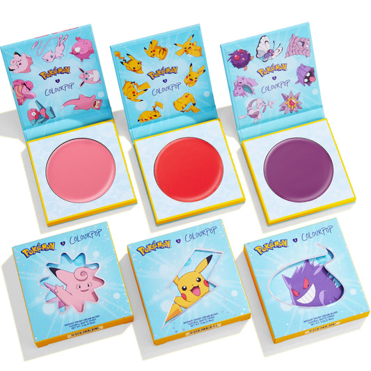 Electrifying Dreams ColourPop Cream Blush trio displayed in a flatlay, three open pans in pink, bold coral red, and violet, above matching boxes with Pokémon art of Clefairy, Pikachu, and Gengar - limited-edition ColourPop Cream Blush set.