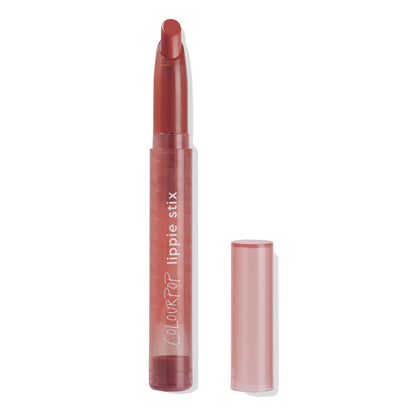 ColourPop Lippie Stix Goal Digger shown uncapped, twist-up lipstick crayon revealing a rosy‑brown bullet in a translucent mauve tube with white lettering, the cap set to the right on a white background.