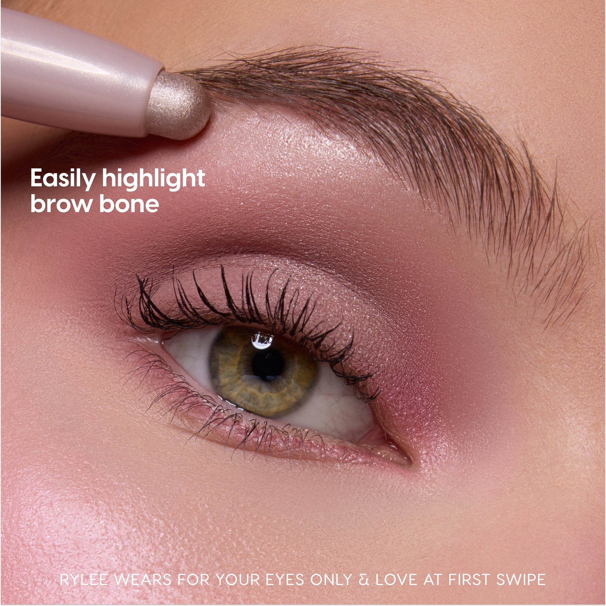 Heart to Get For Your Eyes Only Shadow Stix softly highlighting the brow bone on a close-up hazel eye with pink shimmer eyeshadow, showcasing creamy blendable payoff for easy brow and lid definition makeup look.