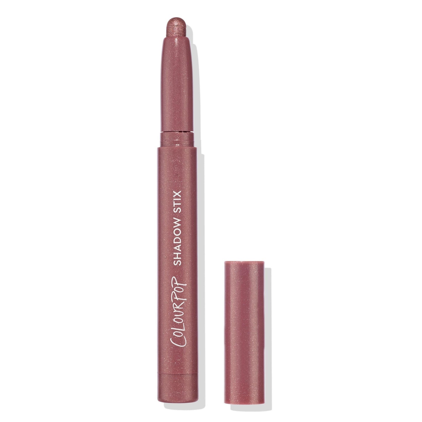 ColourPop Shadow Stix in Next Spot stands uncapped with the rounded shimmer tip exposed, showing a rosy mauve metallic shade; slim pencil with ColourPop Shadow Stix branding, cap beside it on a clean white background.