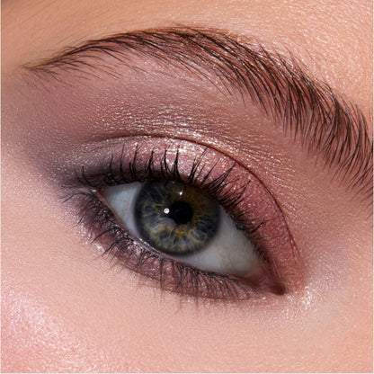 Close-up of a blue-green eye wearing Twilight-inspired Coven Clash Jelly Much Duo, showing shimmery mauve and rose-gold eyeshadow blended across the lid and crease for a soft, metallic glam look.